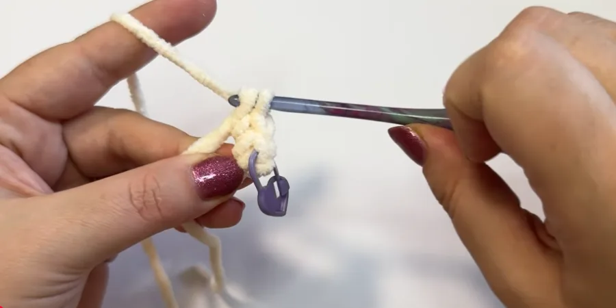 Beginning of the crochet cat body with a stitch marker