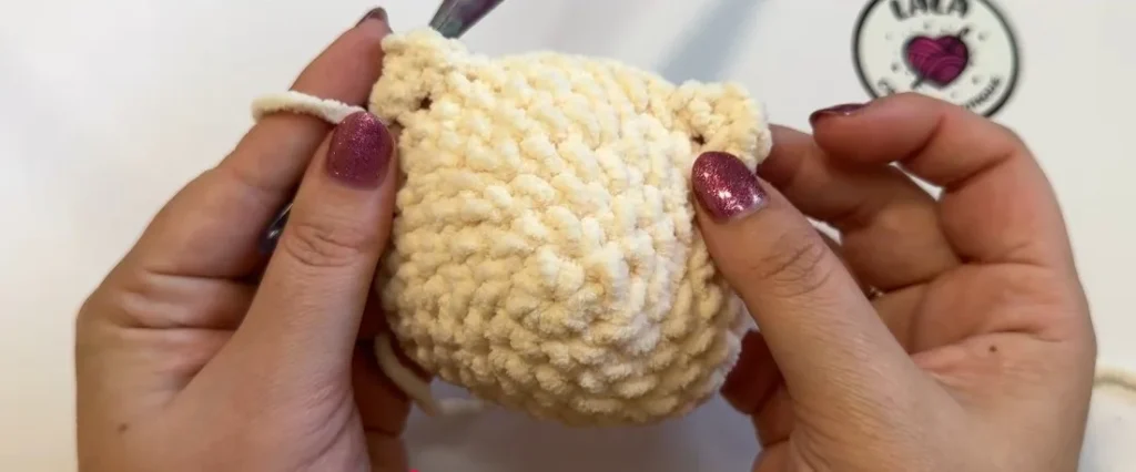 Crocheted cat body with two pointed ears