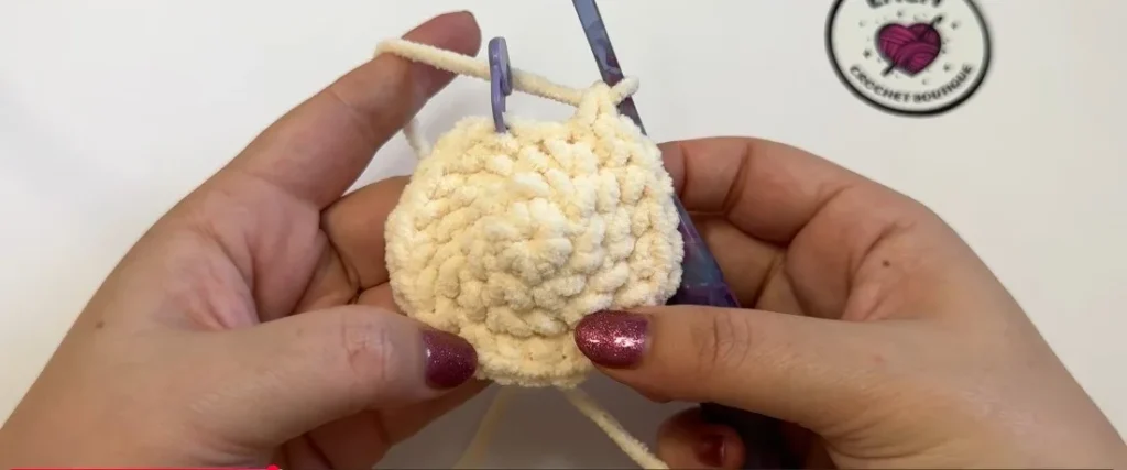 Crochet cat body with stitch marker and hook