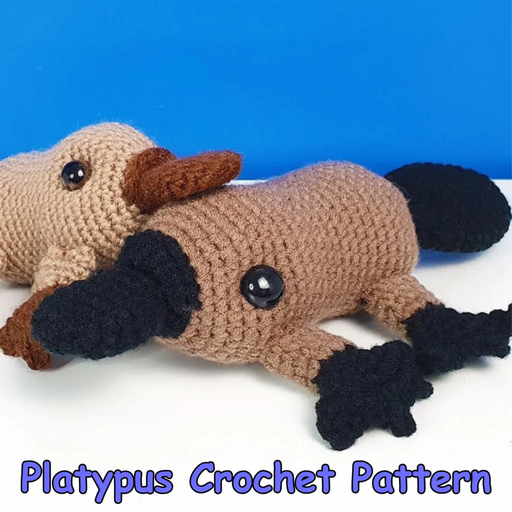 Finished brown and black platypus amigurumi displayed with its large bill, safety eyes, wide tail, and webbed feet.