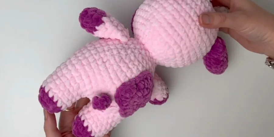attaching tail pieces to the pink strawberry cow crochet plush