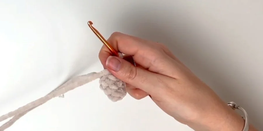 Crocheting a small beige horn for the strawberry cow amigurumi