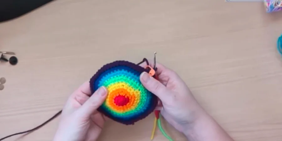 Colorful rainbow turtle shell top with concentric crochet rounds.