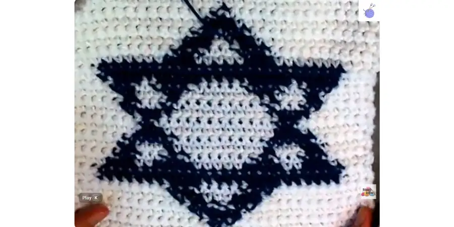 Finished Crochet Star of David Granny Square with a blue Star of David on a white rectangular crochet panel