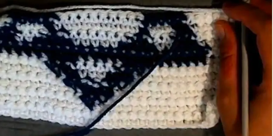 Row 15 of the Crochet Star of David Granny Square showing blue color changes within the white crochet fabric