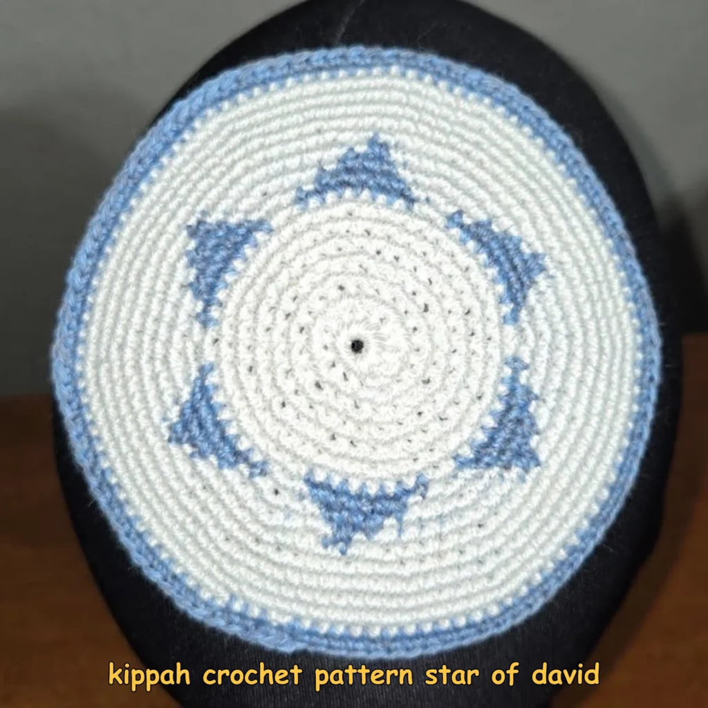 Finished white crocheted kippah with a blue Star of David motif and blue edging displayed on a head form.