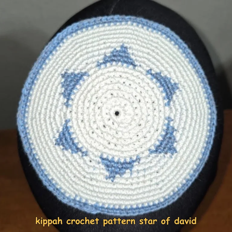 Finished white crocheted kippah with a blue Star of David motif and blue edging displayed on a head form.
